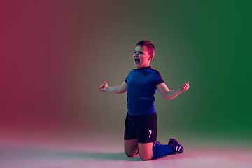 Image showing Teen male football or soccer player, boy on gradient background in neon light - motion, action, activity concept