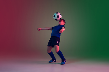 Image showing Teen male football or soccer player, boy on gradient background in neon light - motion, action, activity concept