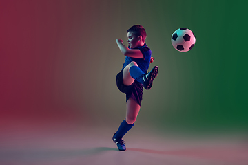 Image showing Teen male football or soccer player, boy on gradient background in neon light - motion, action, activity concept