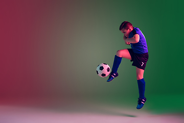 Image showing Teen male football or soccer player, boy on gradient background in neon light - motion, action, activity concept