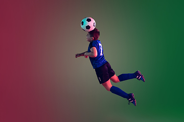 Image showing Teen male football or soccer player, boy on gradient background in neon light - motion, action, activity concept