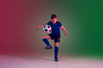 Image showing Teen male football or soccer player, boy on gradient background in neon light - motion, action, activity concept