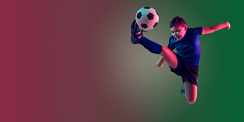 Image showing Teen male football or soccer player, boy on gradient background in neon light - motion, action, activity concept