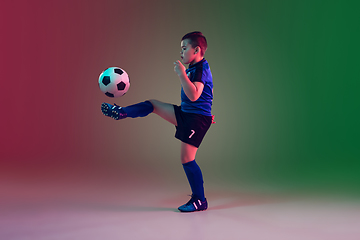 Image showing Teen male football or soccer player, boy on gradient background in neon light - motion, action, activity concept