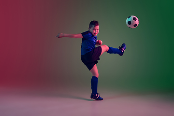 Image showing Teen male football or soccer player, boy on gradient background in neon light - motion, action, activity concept