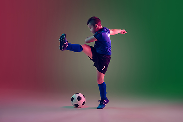 Image showing Teen male football or soccer player, boy on gradient background in neon light - motion, action, activity concept