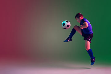 Image showing Teen male football or soccer player, boy on gradient background in neon light - motion, action, activity concept