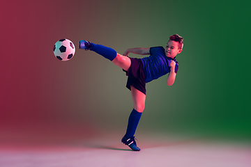 Image showing Teen male football or soccer player, boy on gradient background in neon light - motion, action, activity concept