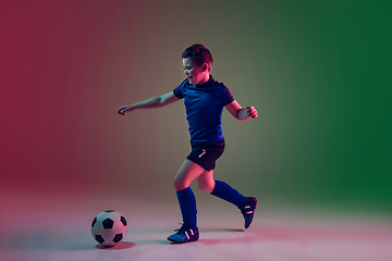 Image showing Teen male football or soccer player, boy on gradient background in neon light - motion, action, activity concept