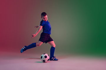 Image showing Teen male football or soccer player, boy on gradient background in neon light - motion, action, activity concept