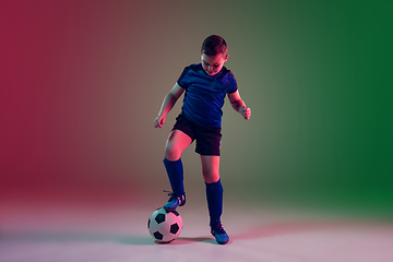 Image showing Teen male football or soccer player, boy on gradient background in neon light - motion, action, activity concept