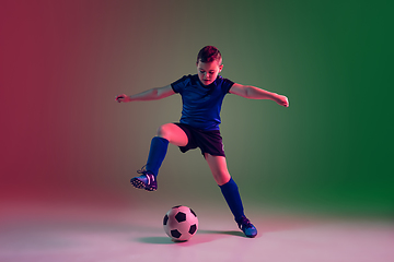 Image showing Teen male football or soccer player, boy on gradient background in neon light - motion, action, activity concept