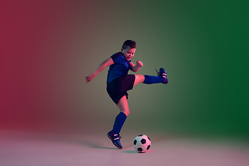 Image showing Teen male football or soccer player, boy on gradient background in neon light - motion, action, activity concept