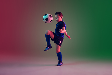 Image showing Teen male football or soccer player, boy on gradient background in neon light - motion, action, activity concept