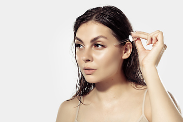 Image showing Close up of beautiful young woman over white background. Cosmetics and makeup, natural and eco treatment, skin care.