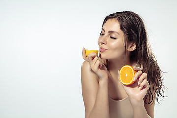 Image showing Close up of beautiful young woman over white background. Cosmetics and makeup, natural and eco treatment, skin care.