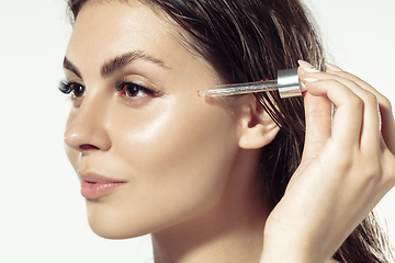 Image showing Close up of beautiful young woman over white background. Cosmetics and makeup, natural and eco treatment, skin care.