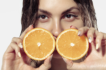 Image showing Close up of beautiful young woman over white background. Cosmetics and makeup, natural and eco treatment, skin care.