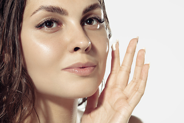 Image showing Close up of beautiful young woman over white background. Cosmetics and makeup, natural and eco treatment, skin care.