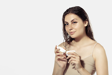 Image showing Close up of beautiful young woman over white background. Cosmetics and makeup, natural and eco treatment, skin care.