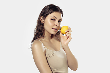 Image showing Close up of beautiful young woman over white background. Cosmetics and makeup, natural and eco treatment, skin care.