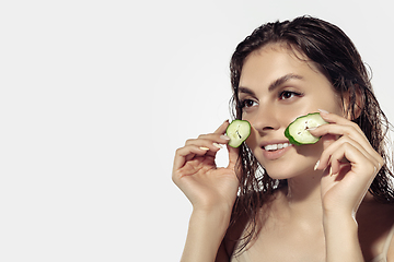 Image showing Close up of beautiful young woman over white background. Cosmetics and makeup, natural and eco treatment, skin care.