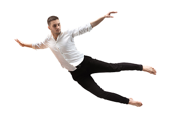 Image showing Mid-air beauty. Full length studio shot of attractive young man hovering in air and keeping eyes closed