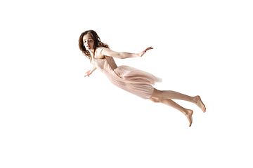 Image showing Mid-air beauty. Full length studio shot of attractive young woman hovering in air and keeping eyes closed