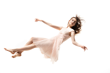 Image showing Mid-air beauty. Full length studio shot of attractive young woman hovering in air and keeping eyes closed