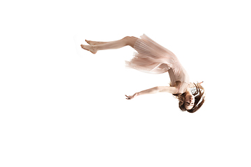 Image showing Mid-air beauty. Full length studio shot of attractive young woman hovering in air and keeping eyes closed