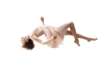 Image showing Mid-air beauty. Full length studio shot of attractive young woman hovering in air and keeping eyes closed