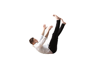 Image showing Mid-air beauty. Full length studio shot of attractive young man hovering in air and keeping eyes closed