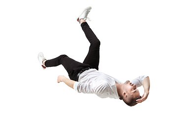 Image showing Mid-air beauty. Full length studio shot of attractive young man hovering in air and keeping eyes closed