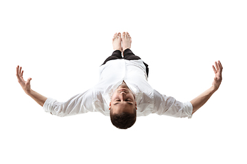 Image showing Mid-air beauty. Full length studio shot of attractive young man hovering in air and keeping eyes closed