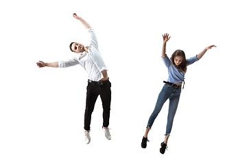 Image showing Mid-air beauty. Full length studio shot of attractive young woman and man hovering in air and keeping eyes closed