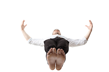 Image showing Mid-air beauty. Full length studio shot of attractive young man hovering in air and keeping eyes closed