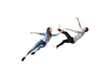 Image showing Mid-air beauty. Full length studio shot of attractive young woman and man hovering in air and keeping eyes closed