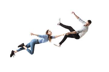 Image showing Mid-air beauty. Full length studio shot of attractive young woman and man hovering in air and keeping eyes closed