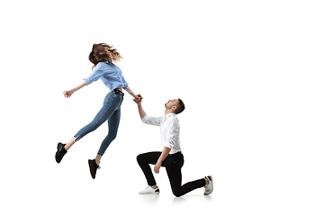 Image showing Mid-air beauty. Full length studio shot of attractive young woman and man hovering in air and keeping eyes closed
