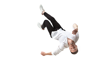 Image showing Mid-air beauty. Full length studio shot of attractive young man hovering in air and keeping eyes closed