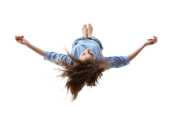 Image showing Mid-air beauty. Full length studio shot of attractive young woman hovering in air and keeping eyes closed