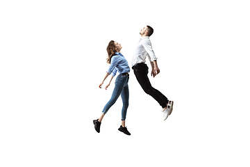 Image showing Mid-air beauty. Full length studio shot of attractive young woman and man hovering in air and keeping eyes closed