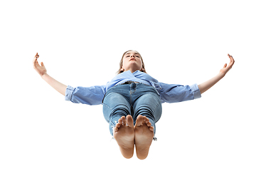 Image showing Mid-air beauty. Full length studio shot of attractive young woman hovering in air and keeping eyes closed