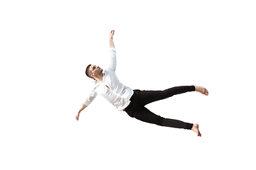 Image showing Mid-air beauty. Full length studio shot of attractive young man hovering in air and keeping eyes closed