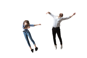 Image showing Mid-air beauty. Full length studio shot of attractive young woman and man hovering in air and keeping eyes closed