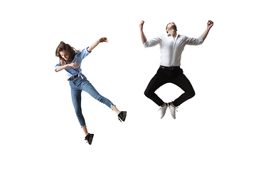 Image showing Mid-air beauty. Full length studio shot of attractive young woman and man hovering in air and keeping eyes closed