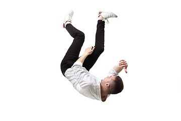 Image showing Mid-air beauty. Full length studio shot of attractive young man hovering in air and keeping eyes closed