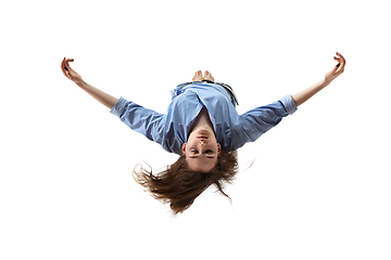 Image showing Mid-air beauty. Full length studio shot of attractive young woman hovering in air and keeping eyes closed