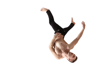 Image showing Mid-air beauty. Full length studio shot of attractive young man hovering in air and keeping eyes closed