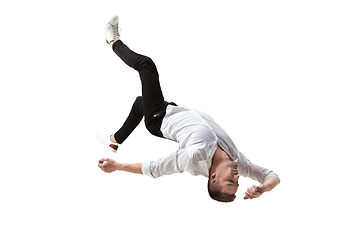 Image showing Mid-air beauty. Full length studio shot of attractive young man hovering in air and keeping eyes closed